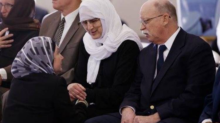 Ed, right, and Paula Kassig, center, parents of Peter Kassig, talk with Lina Midani, of Indianapolis, before funeral prayers were held in the mosque at Al-Huda Foundation in Fishers, Ind., Friday, Nov. 21, 2014. - The Associated Press
