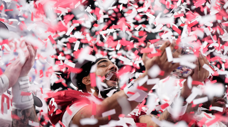 Indiana wide receiver Elijah Sarratt (13) holds up the trophy after the Peach Bowl NCAA college football playoff semifinal against Oregon, Friday, Jan. 9, 2026, in Atlanta. - Brynn Anderson / AP Photo