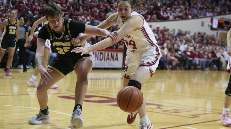Purdue's Rickie Woltman (35) and Indiana's Mackenzie Holmes (54) battle for a loose ball during the first half of an NCAA college basketball game, Sunday, Feb. 19, 2023, in Bloomington, Indiana. - AP Photo/Darron Cummings
