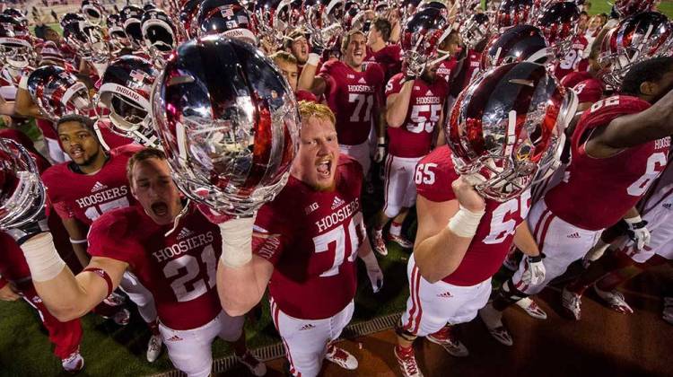 Indiana players sing the school song to their fans after an NCAA college football game win against Illinois in 2013.  - AP Photo/Doug McSchooler