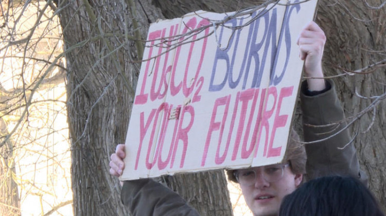 A protest sign at Sunrise Bloomington's rally to demand Indiana University to divest from fossil fuels.  - (Rebecca Thiele/IPB News)