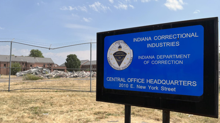 A fence stands in front of the rubble of buildings that were once part of the Indiana Women's Prison on Indianapolis’ Near east side - Jill Sheridan/WFYI