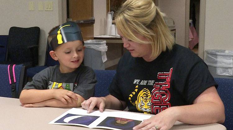 Danielle Reynolds and her son, Jackson, work on reading skills following his graduation from UPSTART. - Lindsey Wright/WFIU