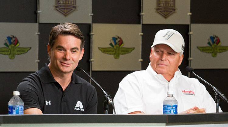 Jeff Gordon, right, speaks to the media as team owner Rick Hendrick looks on at the Indianapolis Motor Speedway Friday morning. - Doug Jaggers