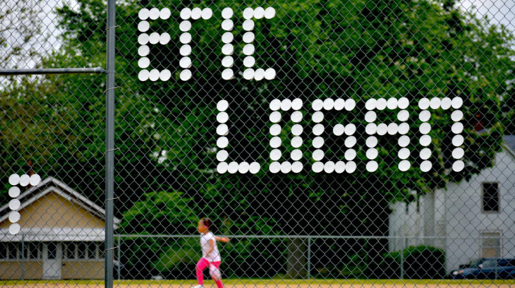 Eric Logan's name written in styrofoam cups on a fence surrounding a baseball field in South Bend. - Justin Hicks/IPB News