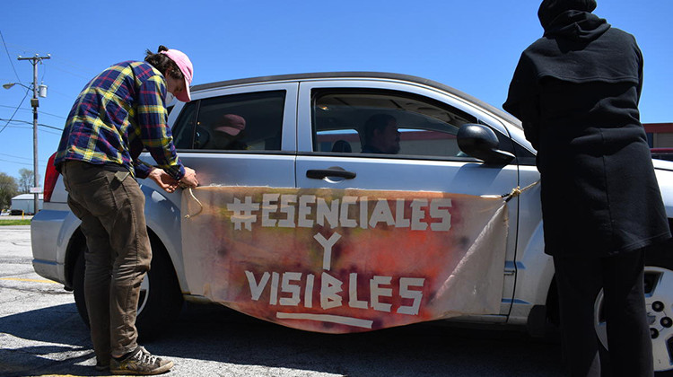 Demonstrators hang a banner from a car before the protest in Elkhart, Indiana. - Justin Hicks/ IPB News