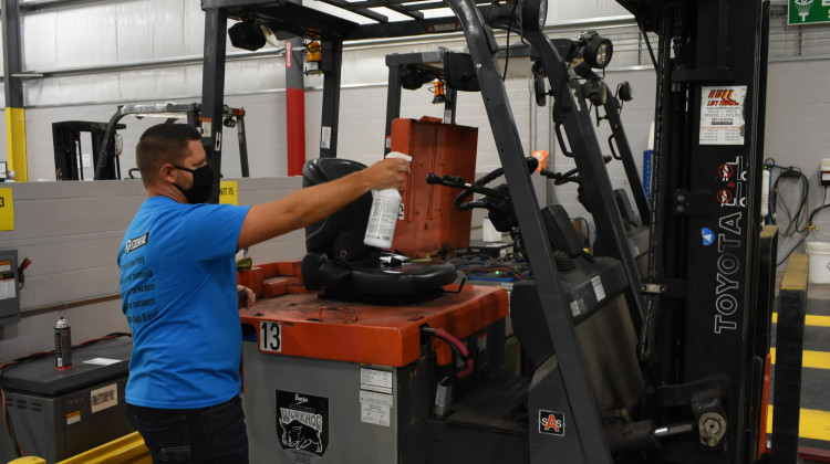 A worker sprays a forklift at an Elkhart factory in accordance with the company's COVID-19 safety standards.  - Justin Hicks / IPB News