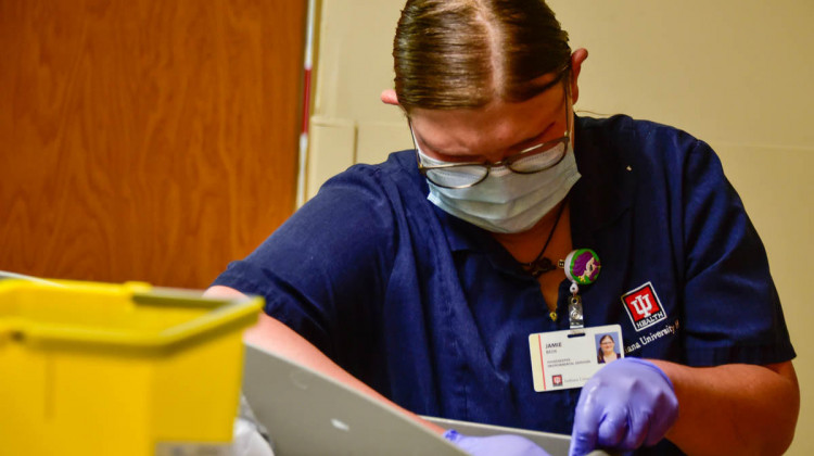 Jamie Beck, a housekeeper at IU Health Ball Memorial Hospital, completes a log on the rooms she has cleaned as part of her daily routine. - Justin Hicks/ IPB News