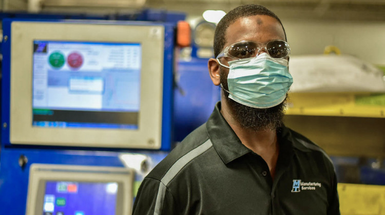 Dexter Loftin poses for a portrait in front of a friction welding machine at Manufacturing Technology Inc. in South Bend. - Justin Hicks/IPB News