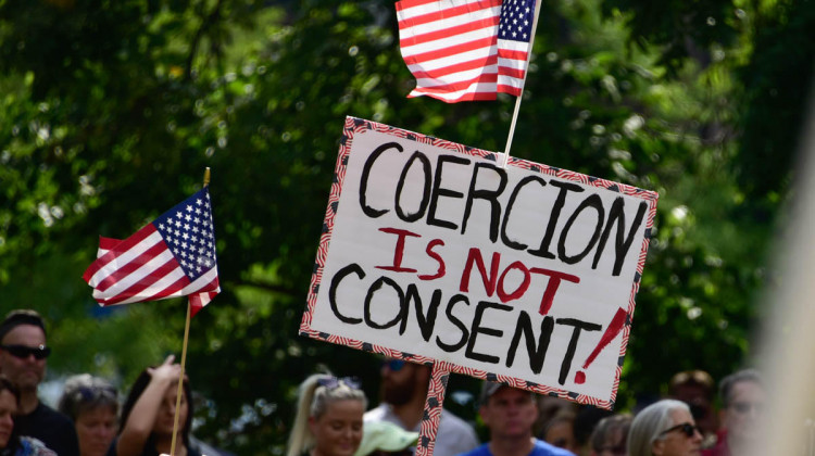 A demonstrator holds a sign at a rally outside the Indiana Statehouse in September opposing any COVID-19 vaccine requirements.  - (Justin Hicks/IPB News)