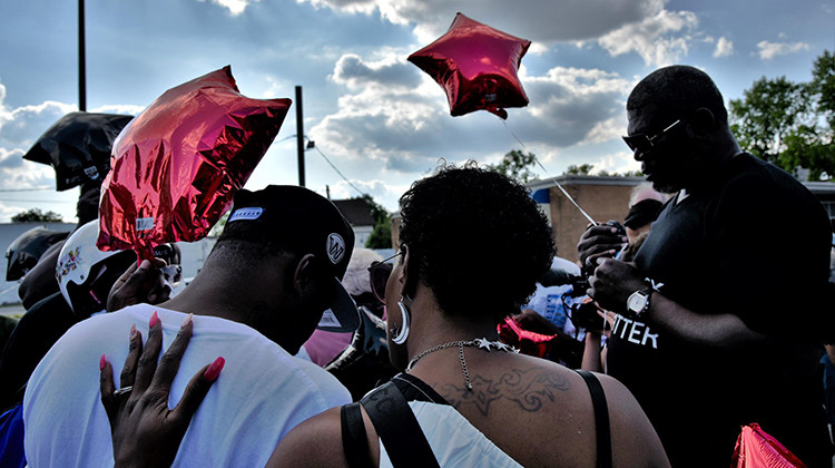 Some of Eric Logan’s family and close friends held a memorial service Tuesday night and marched to demand justice one year after his death. - Justin Hicks/IPB News