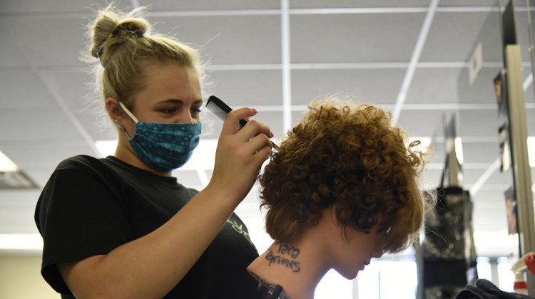 A cosmetology student at the AK Smith Career Center in Michigan City works on a mannequin for a class assignment. Legislation would have cut state funding for cosmetology classes.  - Justin Hicks/IPB News