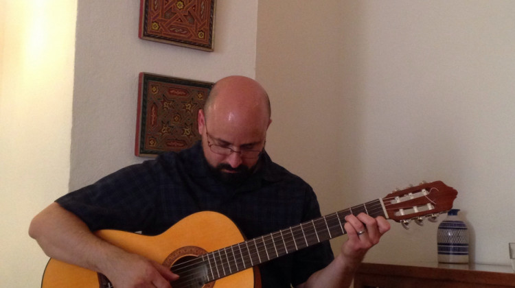 John Alvarado plays his guitar.