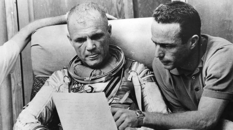Glenn checks over notes with backup pilot Scott Carpenter after a simulated flight in 1962, prior to the Mercury-Atlas 6 mission at Cape Canaveral. The object of the mission was to put the first American spaceman into orbit around the Earth.