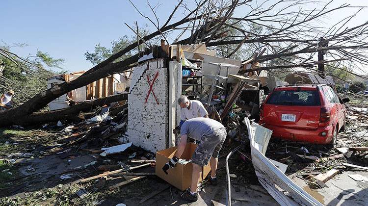 Residents sort through personal items at the home of Terry Munson, Thursday, Aug. 25, 2016, in Kokomo, Ind. Munson's home was hit by a tornado that passed through the area Wednesday afternoon. -  AP Photo/Darron Cummings