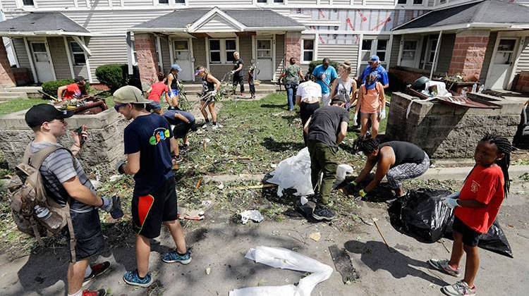 Students from Kokomo schools pitch in and help cleanup debris in a housing area, Thursday, Aug. 25 in Kokomo, Ind. - AP Photo/Darron Cummings