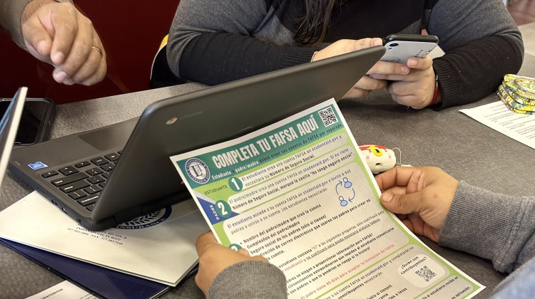 A family works on completing the FAFSA form at Lawrence Central High School on Wednesday, April 3, 2024. - Rachel Fradette / WFYI