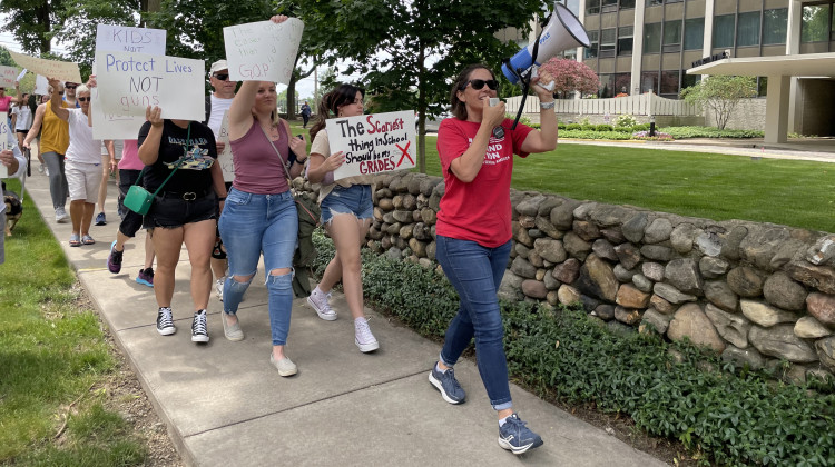 Becca McCracken, a volunteer with the gun reform group Moms Demand Action, leads protesters in a chant while marching from Tarkington Park  to the Indiana governor’s mansion. Hundreds gathered to protest gun violence as part of the national March for Our Lives rallies.  - Darian Benson/WFYI