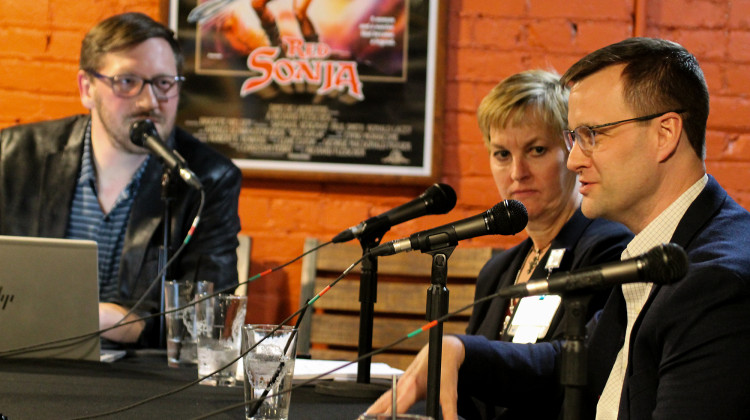 Covering Kids and Families policy director Mark Fairchild, right, answers a text question on how to predict the cost of a single-payer health care system at Damsel Brew Pub in Evansville during an Issues & Ales conversation.  - Lauren Chapman/IPB News