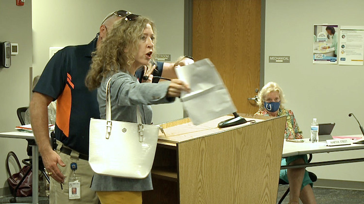 Margaret Menge was escorted out of the MCCSC co-lab building by a school resource officer after she refused to wear a mask at school board meeting last August. - Ethan Burks/WFIU-WTIU