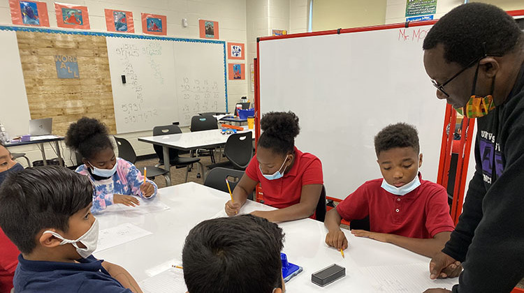 Matchbook interventionist Warner Moses helps fifth graders calculate volume.  - (Elizabeth Gabriel/WFYI)