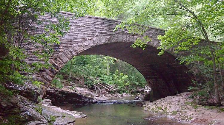 A bridge over McCormick's Creek in McCormick's Creek State Park, which was established in 1916. - McGhiever, CC-BY-SA-3.0