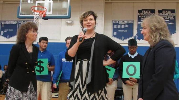 English teacher Melody Coryell speaks to Shortridge High School students after receiving the $25,000 Milken Award from Jane Foley, senior vice president of the Milken Educator Awards (left) and Indiana state Superintendent Glenda Ritz (right).  - Scott Elliott / Chalkbeat Indiana