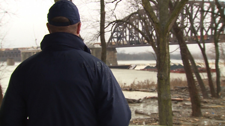 U.S. Coast Guard Lt. Cmdr. Michael Metz surveys the coal barges stuck by the McAlpine Dam on Dec. 31, 2018. - Steve Burns/WTIU