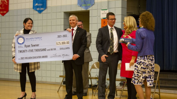 Ryan Towner, third from right, reacts after learning he is receiving the $25,000 cash award. Indiana Secretary of Education Katie Jenner is second from right. - Jakob Lazzaro/WVPE