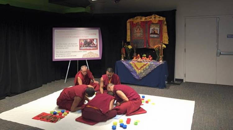 The monks of Tashi Kylil monastery are creating a peace sand mandala at the Children's Museum of Indianapolis. - The Children's Museum