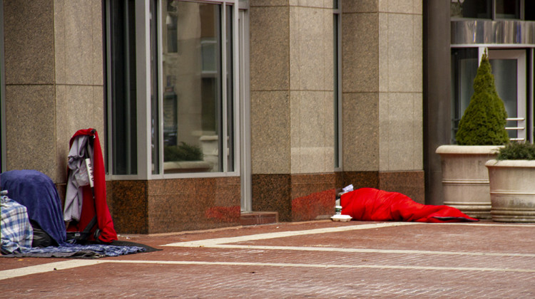 Person experiencing homelessness on Monument Circle. (Jill Sheridan/WFYI)