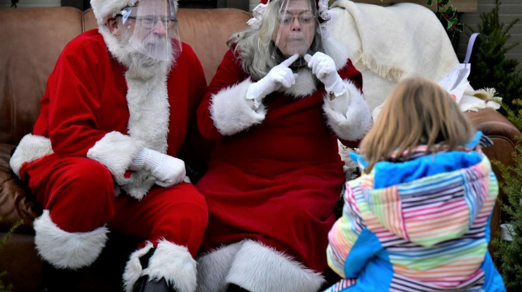 Santa and Mrs. Claus speak with a child at a garden store in Elkhart. - (Justin Hicks/IPB News)