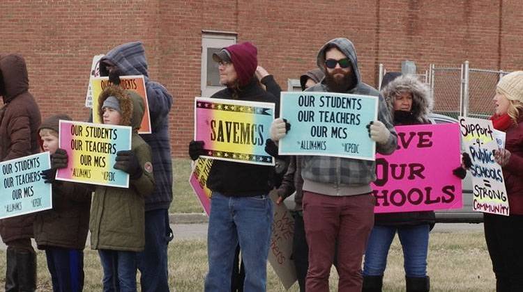 A small group of rally-goers demonstrate outside of a Muncie school board meeting.  - FILE PHOTO: Tony Sandleben/IPR News