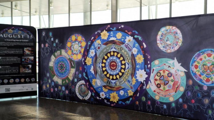 Titled “August 15,” the mural’s focal point is an abstract clock, which artist Tiffany Black said represents the waiting evacuees had to endure. - Alan Mbathi/IPB News