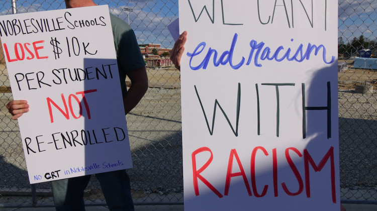 Parents hold signs protesting the teaching of racism at Noblesville Schools outside the district community center on Thursday, May 13, 2021. - Eric Weddle/WFYI News