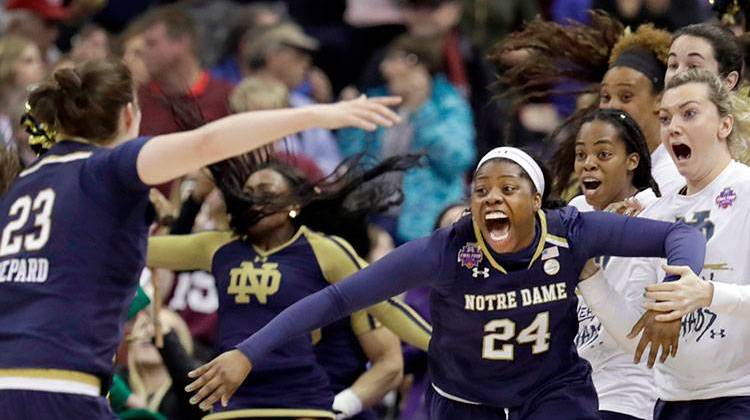 Notre Dame's Arike Ogunbowale (24) is congratulated by teammate Jessica Shepard (23) after sinking a 3-point basket to defeat Mississippi State 61-58 in the final of the women's NCAA Final Four college basketball tournament, Sunday, April 1, 2018, in Columbus, Ohio. - AP Photo/Tony Dejak