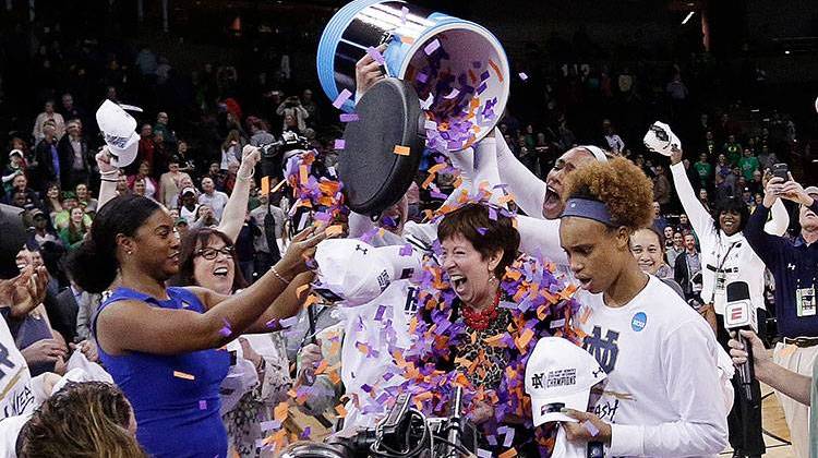 Notre Dame players pour confetti onto head coach Muffet McGraw, center, after defeating Oregon 84-74 in a regional final at the NCAA women's college basketball tournament, Monday, March 26, 2018, Spokane, Wash.  - AP Photo/Young Kwak