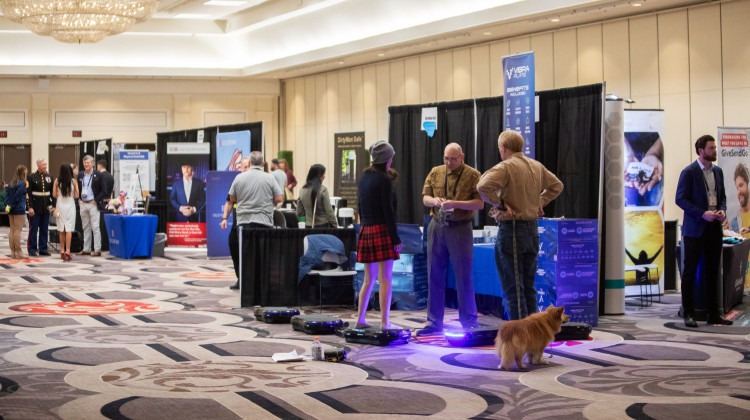 Attendees visit booths at the RePlatform conference in Las Vegas in March. The conference crowd was a hybrid of anti-vaccine activists, supporters of former President Donald Trump and Christian conservatives. - Krystal Ramirez / NPR