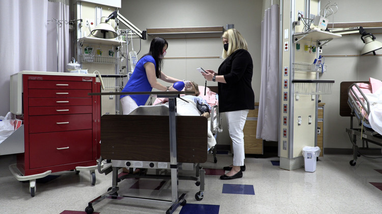 Nursing school instructors Erin McGuire and Kristin Yosanovich demonstrate how they use dummies to teach students. - (Steph Whiteside/Side Effects Public Media)