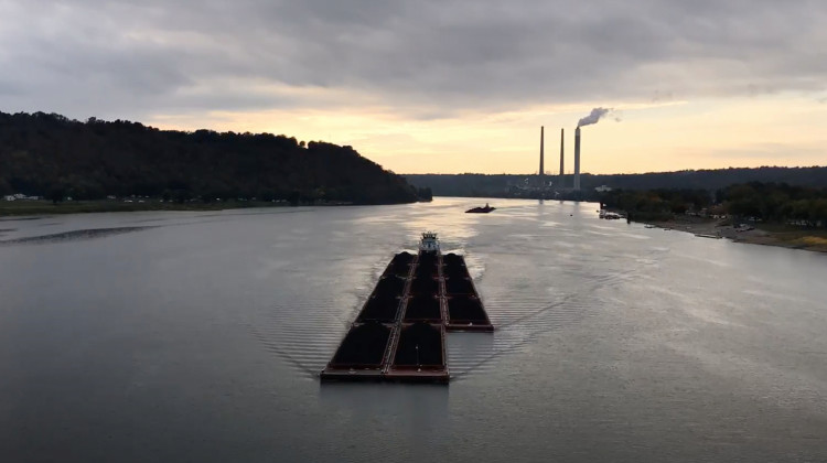 FILE PHOTO: Justin Hicks / IPB News - A barge floating down the Ohio River at sunset near Madison.