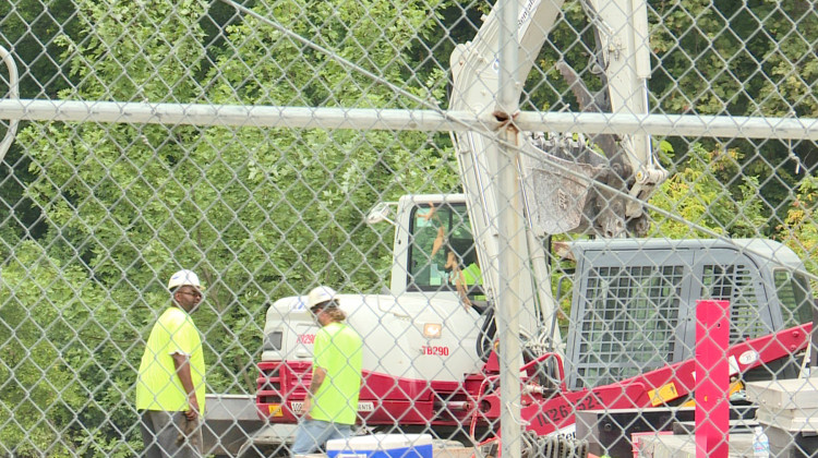 A contractor hired by Citizens Energy is cleaning up oily rocks and material from the area of the river where the oil was discharged this week. - Lauren Chapman/IPB News