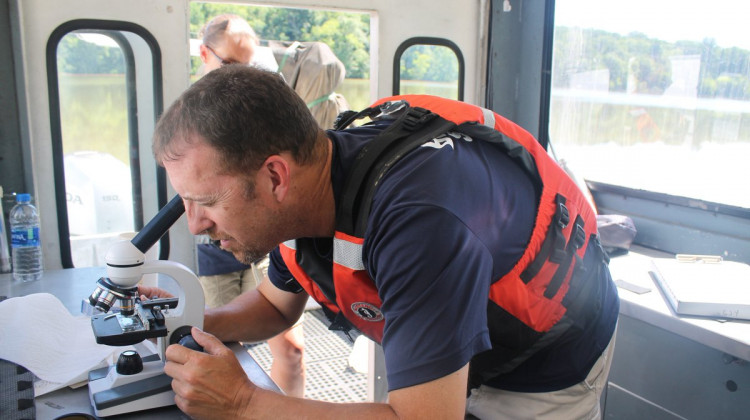 An ORSANCO member checks water samples during routine algae monitoring.  - @ORSANCOchannel/Twitter