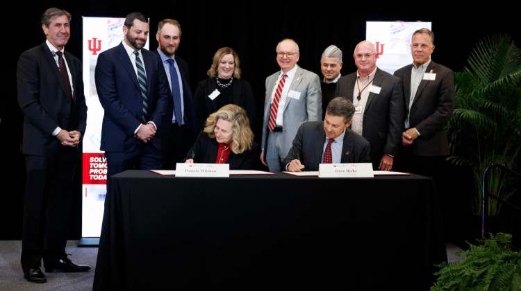 Indiana University President Pamela S. Whitten and Eli Lilly and Company Chair and CEO David Ricks sign an agreement during an event at IU Indianapolis on Wednesday, Dec. 3, 2025. - Liz Kaye / Indiana University