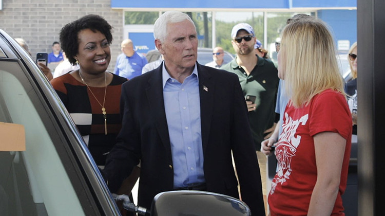 Former Vice President Mike Pence and Jennifer-Ruth Green, the Republican candidate for the District 1 Congressional seat, visit a gas station in Hobart, Indiana. Jayme Wampler, from Portage, fills her tank during a price drop, funded by Americans for Prosperity. - Gemma DiCarlo/WVPE