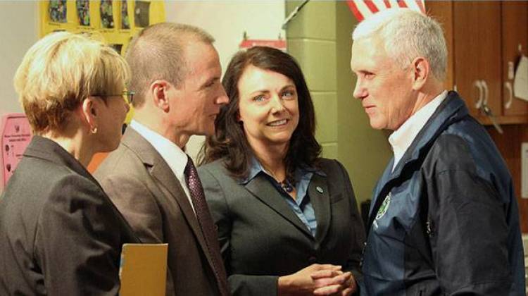 Gov. Mike Pence (right) greets Early Learning Indiana CEO Ted Maple (second from left) and Melanie Brizzi of the FSSA (second from right) at Wayne Township Preschool Thursday. - Rachel Morello/StateImpact Indiana