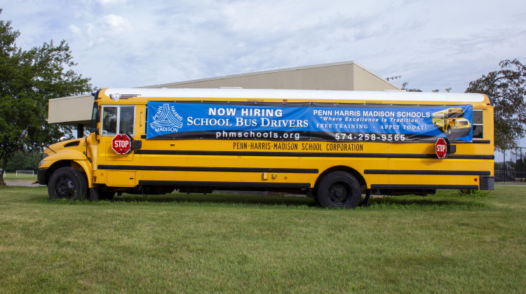 A school bus outside Penn High School in Mishawaka advertises the need for bus drivers. The high school is part of the Penn-Harris-Madison School Corporation, one of many districts trying to hire support staff for the upcoming school year. -  Jakob Lazzaro / WVPE