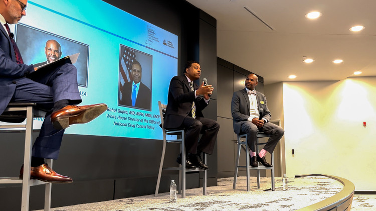 Brian Tabor, president of the Indiana Hospital Association, moderates a conversation between Dr. Rahul Gupta and Dr. Jerome Adams. Gupta directs the Office of National Drug Control Policy. Adams directs the Health Equity Initiatives at Purdue University and previously served as the U.S. surgeon general and Indiana health commissioner.  - Abigail Ruhman/IPB News