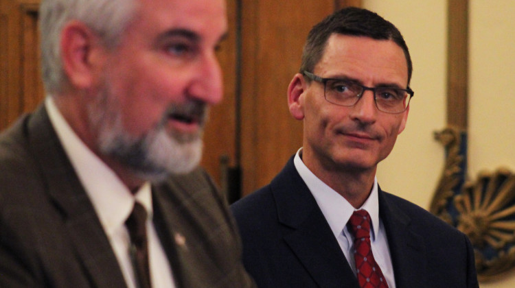 Morgan County Judge Peter Foley, at right, looks on as Gov. Eric Holcomb, at left, announces Foley's appointment to the Indiana Court of Appeals on Sept. 14, 2022. - Brandon Smith/IPB News