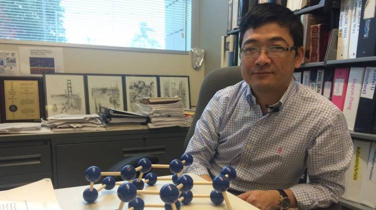 Peter Ye, an electrical engineering professor at Purdue University, with his model of black phosphorus - Sarah Fentem/IPBS