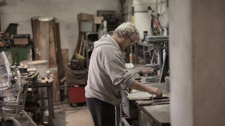 A man works in a studio. In the United States, 19 percent of adults are employed beyond the traditional retirement age of 65. - Andrea Piacquadio/Pexels
